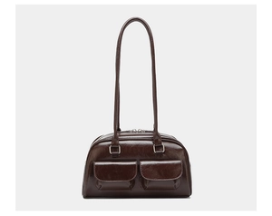 Detailed view of dark brown oil wax leather shoulder bag with vintage dual front pockets