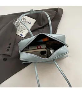 Interior view of light blue leather handbag showing spacious capacity for daily items