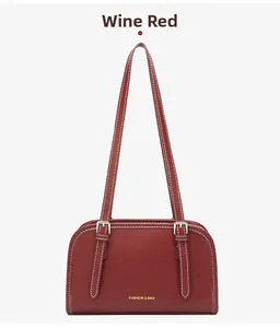 Detail of burgundy underarm bag with white stitching and Fashion & Bag logo
