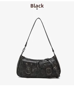 Detailed view of a vintage black motorcycle bag with two functional metal buckle pockets