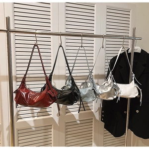Detailed row of vintage hobo shoulder bags in various colors with side pockets and tassels