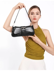 Detail of black stone-pattern baguette bag with silver buckle and stylish chain strap