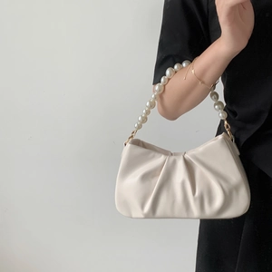 Detailed close-up of pearl bead handle and ruched faux leather cloud bag texture