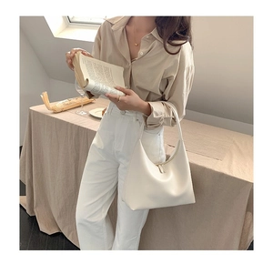 Cremeweiße Hobo-Tasche in Halbmondform mit minimalistischem Design für den Alltag