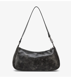 Close-up of vintage textured faux leather and metal chain detail on motorcycle bag