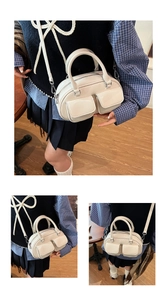 Detail view of cream Boston bag showing glossy leather texture and front flap pockets