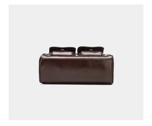 Detailed back view of a dark brown oil wax leather bowling bag with vintage pockets