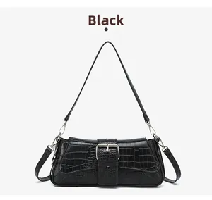 Detail of black stone-patterned bag featuring silver square buckle and dual strap options