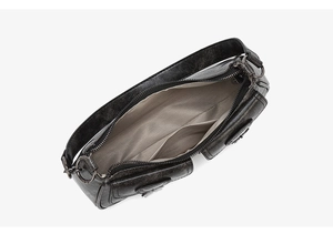 Macro view of the spacious inner lining and multiple pockets of this black leather bag