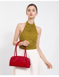Detail of red leather Boston bag featuring contrast white stitching and minimalist handles
