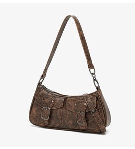 Detail view of vintage dark brown faux leather shoulder bag with two metal buckle pockets