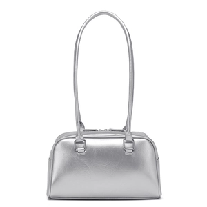 Detail view of silver oil-wax leather bowling bag with side pockets and dual thin straps