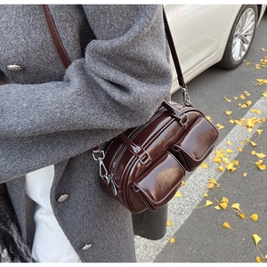 Retro wax leather Boston bag in dark brown showing shoulder carry style in autumn setting