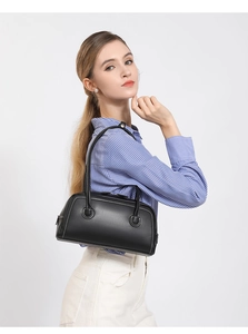 Detail of black Boston bag with white contrast stitching and long shoulder straps