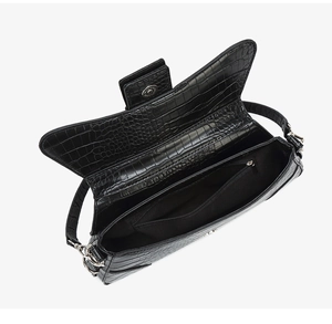 Interior view of crocodile pattern crossbody bag showing fabric lining and zipper pocket