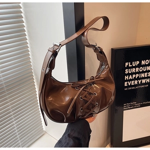 Dark coffee patent leather hobo bag with lace-up ribbon details and silver hardware
