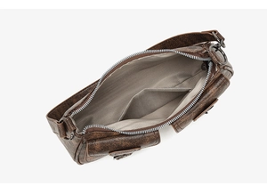 Interior view of brown vintage shoulder bag showing herringbone lining and inner pocket