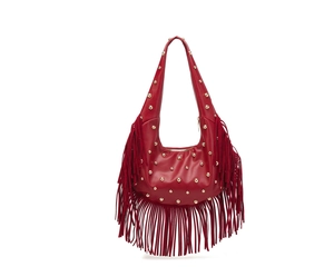 Detail view of red hobo bag with gold rivets and long fringe tassels on white background
