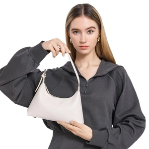 Minimalist creamy white crescent shoulder bag for women with adjustable strap on model