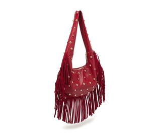 Detail of red crescent bag with gold rivets and long fringe tassels on white background