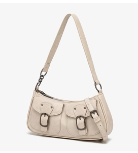 Detail of cream white textured leather shoulder bag with vintage buckles and dual front pockets