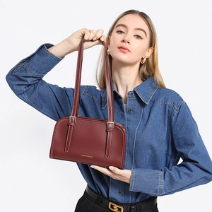 Minimalist deep red leather shoulder bag with white contrast stitching and gold lettering