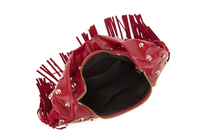 Detail view of red biker bag with gold studs, fringe decor, and black interior pockets