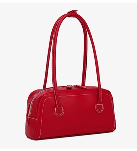Detail view of red Boston bag featuring contrast white stitching and dual silver zippers
