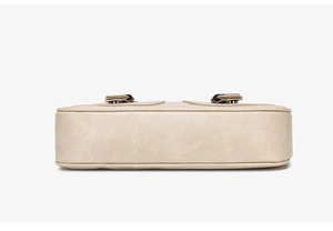 Detailed bottom view of the beige faux leather crossbody bag with rounded edges and soft texture