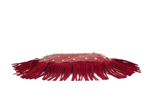 Detailed macro view of wine red leather fringe bag with golden punk rivet accents