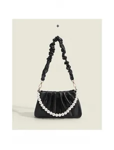 Close-up of black pleated cloud bag featuring an elegant large white pearl decorative chain
