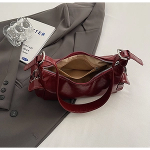 Detailed view of spacious vintage red leather shoulder bag with inner zipper pocket