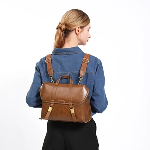 Vintage brown leather backpack for women with gold buckles and adjustable straps