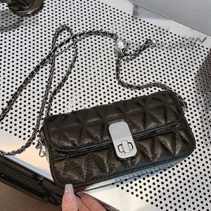 Summer black quilted crossbody bag with silver chain strap and metal ball detail