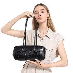 Trendy black patent leather bowling underarm bag with decorative bows for women