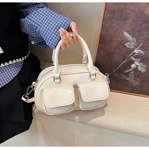 Detailed macro view of cream oil wax leather Boston bag with vintage flap pockets