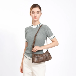 Vintage brown motorcycle shoulder bag in aged leather style with front metal buckle pockets