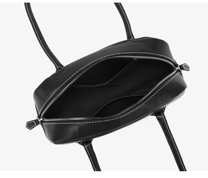 Top view of black retro boston bag showing interior pockets and white contrast stitching