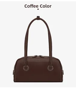 Detail view of coffee brown Boston bag with contrast white stitching and dual zippers
