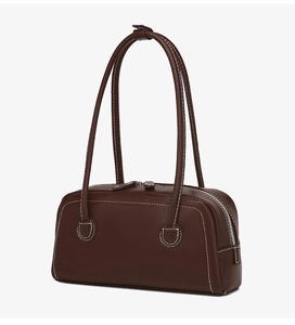 Detailed view of brown leather handbag with contrast stitching and dual zipper closure