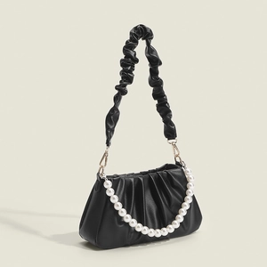 Elegant black pleated cloud handbag with large white pearls and wide shoulder strap