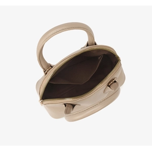 Top view of beige shell handbag showing spacious interior and brown lining detail