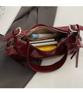 Spacious interior of dark red vintage leather shoulder bag showing daily essentials