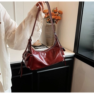 Detail of vintage red shoulder bag with side bow design and silver metal zipper