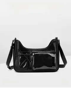 Close-up of black glossy PU handbag featuring bow detail and transparent PVC zipper pocket