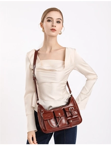 Detailaufnahme der dunkelbraunen Vintage-Tasche mit mehreren Taschen und Silberkette