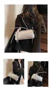 Detail of silver metallic baguette bag with lace ribbon and bow decoration