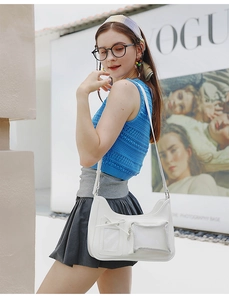 Detail of white 2D design crossbody bag with bow decoration and transparent pockets
