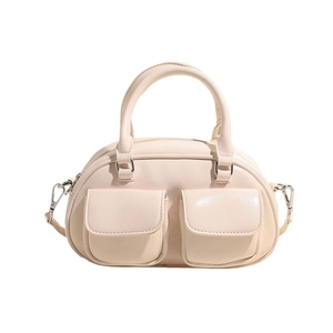 Vintage beige oiled leather bowling bag with functional front pockets and top handles