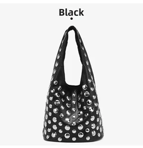 Detailed view of black leather tote bag with silver metal studs and starry rivet design